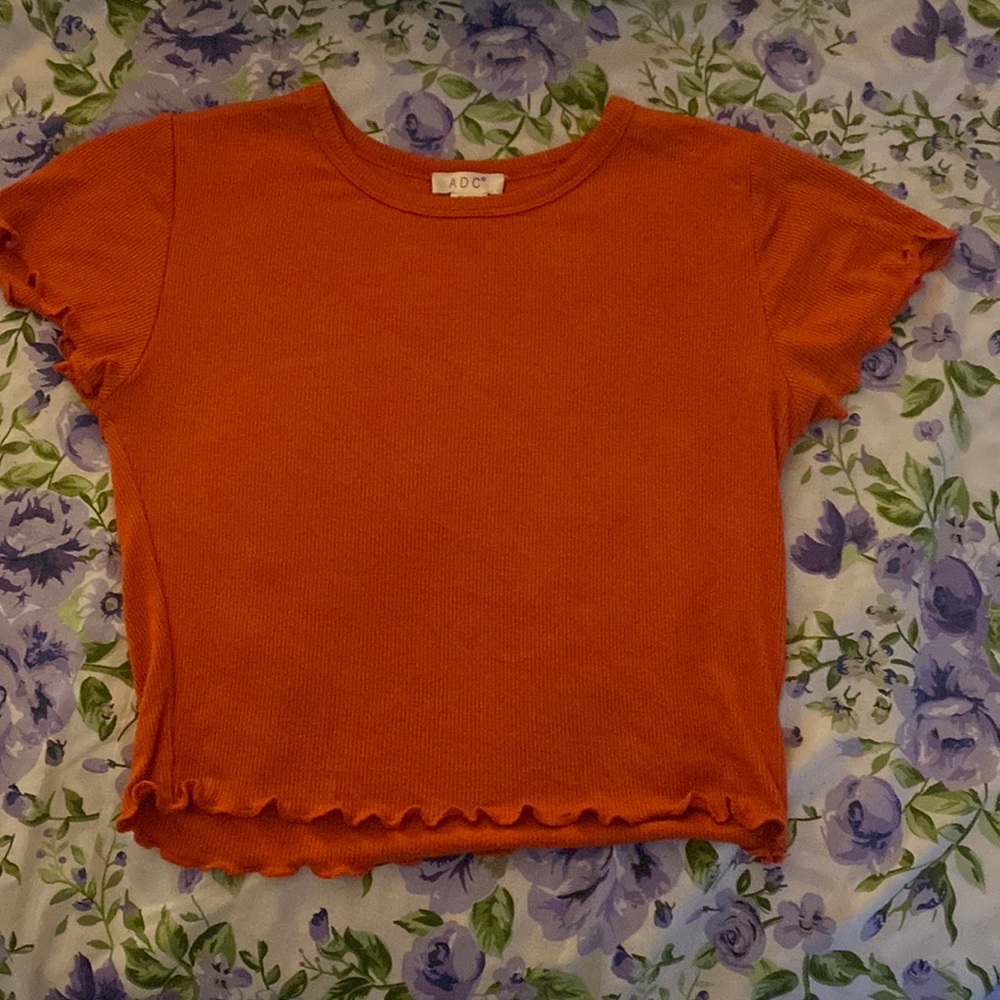 A orange crop top. It’s a very comfortable and simple crop top.